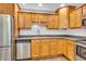 Fully equipped kitchen featuring stainless steel appliances and wooden cabinetry at 6686 Woodcrest Dr, Avon, IN 46123