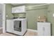 Functional laundry room with modern washer and dryer, sink, and ample cabinet storage at 6686 Woodcrest Dr, Avon, IN 46123