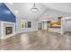 Open-concept living room with a fireplace and connection to the kitchen area at 6686 Woodcrest Dr, Avon, IN 46123