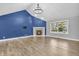 Bright living room with a cozy fireplace, high ceilings, modern floors, and a large window with natural light at 6686 Woodcrest Dr, Avon, IN 46123