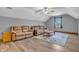 Finished attic space with wood laminate flooring, plush couches, and natural light at 6686 Woodcrest Dr, Avon, IN 46123