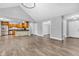 Open-concept living space with hardwood floors connecting a modern kitchen and a bright living area at 6686 Woodcrest Dr, Avon, IN 46123