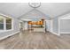 Bright, open-concept living area with hardwood floors and views of the modern kitchen and outdoor space at 6686 Woodcrest Dr, Avon, IN 46123