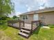 Wooden back deck with weathered steps and railing leading to the home's entrance at 7645 Inverness Dr, Indianapolis, IN 46237
