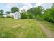 A fenced backyard with a shed, bordered by lush trees and foliage, creating a serene outdoor retreat at 7645 Inverness Dr, Indianapolis, IN 46237