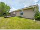 Backyard featuring a wooden deck adjacent to the home, offering outdoor living space at 7645 Inverness Dr, Indianapolis, IN 46237