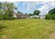 Expansive backyard with a wooden deck, shed, and mature trees, providing ample space for outdoor activities at 7645 Inverness Dr, Indianapolis, IN 46237