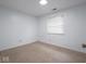 Empty bedroom with neutral walls and carpet, with a window for natural light at 7645 Inverness Dr, Indianapolis, IN 46237