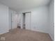 Bedroom featuring carpeting, light-colored walls, and closet, connected to a bathroom at 7645 Inverness Dr, Indianapolis, IN 46237