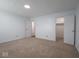 Spacious bedroom features carpeting, neutral paint, and closet with a white door at 7645 Inverness Dr, Indianapolis, IN 46237