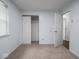 Bedroom featuring carpeting, light-colored walls, window, and closet doors at 7645 Inverness Dr, Indianapolis, IN 46237