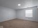 Bright, carpeted bedroom featuring neutral walls and a window for natural light at 7645 Inverness Dr, Indianapolis, IN 46237