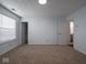 Bedroom with neutral paint, carpet, and access to bathroom via white door at 7645 Inverness Dr, Indianapolis, IN 46237