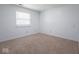 Carpeted bedroom with a window and neutral walls offers a blank canvas at 7645 Inverness Dr, Indianapolis, IN 46237