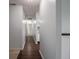 Hallway featuring hardwood floors and access to the kitchen at 7645 Inverness Dr, Indianapolis, IN 46237