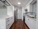 Updated kitchen boasts stainless steel appliances, white cabinetry, and light countertops at 7645 Inverness Dr, Indianapolis, IN 46237