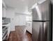 Updated kitchen with stainless steel refrigerator, white cabinets, and modern backsplash at 7645 Inverness Dr, Indianapolis, IN 46237