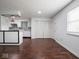 Bright living room featuring hardwood floors, a window, and access to storage with double folding doors at 7645 Inverness Dr, Indianapolis, IN 46237