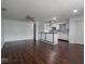 Open-concept living room with dark hardwood floors and a view into the kitchen with white cabinetry at 7645 Inverness Dr, Indianapolis, IN 46237