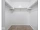 Walk-in closet with white walls, carpet, and shelves for clothing and storage at 7645 Inverness Dr, Indianapolis, IN 46237