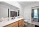 Bright bathroom features a double sink vanity, gray accents, and a view of the walk-in closet at 77 Winding Brook Way, Pendleton, IN 46064