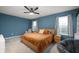 Stylish bedroom with a cozy bed, large windows, a ceiling fan, and soft, neutral decor at 77 Winding Brook Way, Pendleton, IN 46064