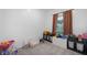 Bright, carpeted bedroom with natural light and decorated with many toys and places to store them at 77 Winding Brook Way, Pendleton, IN 46064