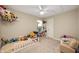 bedroom with a bed full of stuffed animals and cozy reading chair at 77 Winding Brook Way, Pendleton, IN 46064