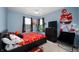 Sports themed bedroom features bed, TV, window, ceiling fan and Patrick Mahomes wall decor at 77 Winding Brook Way, Pendleton, IN 46064