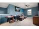 Blue game room features Indy sport decor, an air hockey table, a window, and two grey lounge chairs at 77 Winding Brook Way, Pendleton, IN 46064