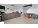 Spacious living room featuring a large sectional sofa and leading to a dining area and staircase at 77 Winding Brook Way, Pendleton, IN 46064