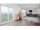 Bright living room featuring wood floors, modern gray sofa, large windows, and a fun play area at 77 Winding Brook Way, Pendleton, IN 46064