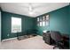 Green office features a large window, ceiling fan, a desk, a printer and a dog crate at 77 Winding Brook Way, Pendleton, IN 46064