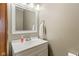The powder room features a white vanity and sink with a framed mirror, enhanced by modern lighting at 787 West St, Whiteland, IN 46184