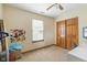 This bedroom features neutral walls, carpet, and a double-door closet, all illuminated by a ceiling fan at 787 West St, Whiteland, IN 46184