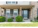 A cozy front porch with seating and a glass accented front door provides curb appeal for this inviting home at 787 West St, Whiteland, IN 46184