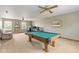 This spacious game room is the perfect entertainment space, featuring a full-size pool table and comfortable seating at 787 West St, Whiteland, IN 46184