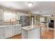 Bright eat-in kitchen featuring an island with stone countertop, modern appliances, and wood flooring at 787 West St, Whiteland, IN 46184