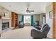 Cozy living room with a fireplace, built-in shelving, and comfortable seating near a large window at 787 West St, Whiteland, IN 46184