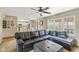 Comfortable living room area showcasing a large window, open access to the kitchen, and a black leather sectional sofa at 787 West St, Whiteland, IN 46184