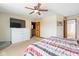 Comfortable main bedroom featuring a TV on a dresser, neutral walls, and a striped bedspread at 787 West St, Whiteland, IN 46184
