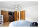 Spacious bedroom with a ceiling fan, hardwood floors, closet and dresser at 8219 Bishops Ln, Indianapolis, IN 46217