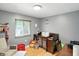 Charming Bedroom with a wooden crib, plush toys, and natural light from the window at 8219 Bishops Ln, Indianapolis, IN 46217