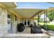 Covered patio featuring a stone exterior, perfect for outdoor gatherings and relaxation at 8219 Bishops Ln, Indianapolis, IN 46217