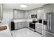 Stylish kitchen features gray cabinetry, stainless steel appliances, light countertops, and modern flooring at 8219 Bishops Ln, Indianapolis, IN 46217