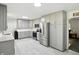 A stylish kitchen features modern stainless steel appliances and sleek light gray cabinets at 8219 Bishops Ln, Indianapolis, IN 46217
