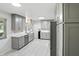 A newly renovated kitchen with light gray cabinetry, stainless steel appliances, and a modern design at 8219 Bishops Ln, Indianapolis, IN 46217