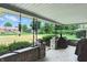 Covered patio with stone pillars, lush greenery, and view of the backyard at 8219 Bishops Ln, Indianapolis, IN 46217