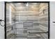 Elegant glass shower showcasing stone-look tile, recessed niche, and modern fixtures at 8219 Bishops Ln, Indianapolis, IN 46217