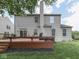 Exterior view of a two-story home with a wooden deck and a chimney at 8415 Alcona Dr, Indianapolis, IN 46237